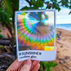 someone holding up a card with an image of the sun shine rainbow glow