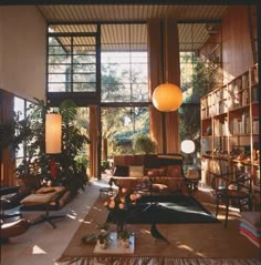 the interior of a house with lots of furniture and bookshelves in it, along with an image of a cat's face