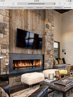 a living room filled with furniture and a flat screen tv mounted on the wall above a fire place