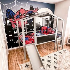 a child's bedroom with a spiderman themed bunk bed