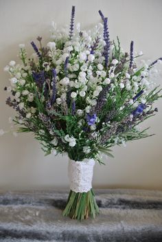 a bouquet of lavenders and white flowers in a vase