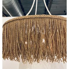 a chandelier made out of rope hanging from the ceiling