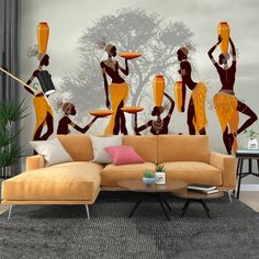 a living room with an orange couch and wall mural depicting african women in traditional garb