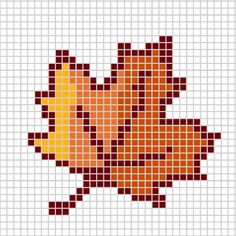 a cross stitch pattern with an orange and yellow leaf