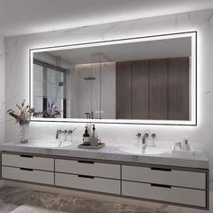 a bathroom with two sinks and a large mirror