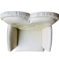 an upholstered white pillow with pleated edges on the top and bottom side