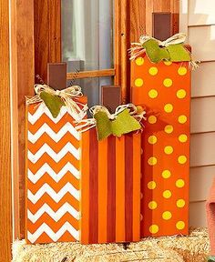 three orange and white bags sitting in front of a door