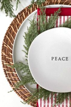 a white plate with the word peace on it sitting next to a red and white striped napkin