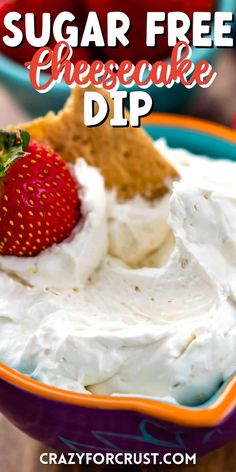 a bowl filled with whipped cream and a strawberry on top