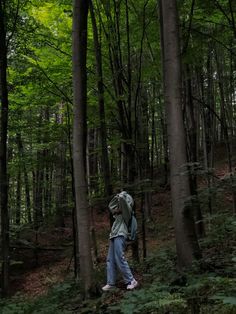 a person walking in the woods with a backpack