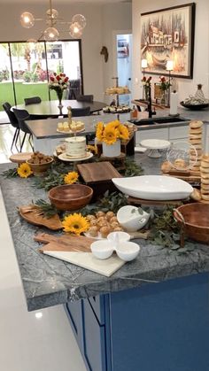 a kitchen counter with sunflowers and plates on it