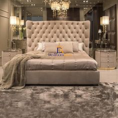 a bedroom with a large bed and chandelier in the corner, along with mirrored walls