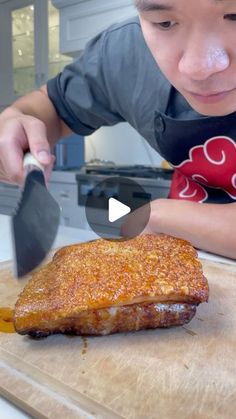 a young boy cutting up food on top of a wooden cutting board with a knife