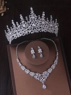 a tiara and earring set on top of a brown box