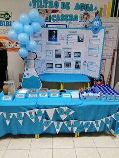 a table with blue and white decorations for a baby's first birthday at a children's hospital