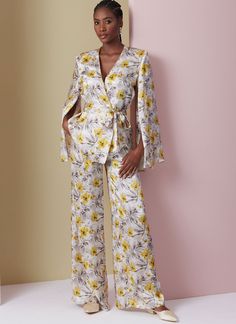 a woman standing in front of a pink wall wearing a white and yellow floral suit