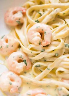 pasta with shrimp and parsley on top in a white bowl, ready to be eaten