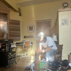 a man sitting on top of a chair in a room