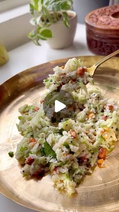 a golden plate topped with rice and vegetables