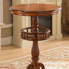 a wooden table sitting on top of a rug next to a fire place in a living room