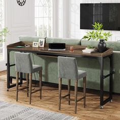 a living room filled with furniture and a flat screen tv on top of a wooden table