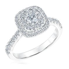 a white gold ring with diamonds on the band and an oval shaped center surrounded by small round