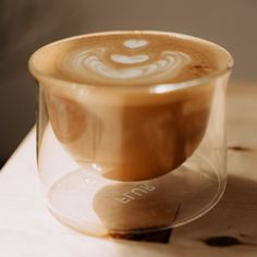 a cappuccino in a glass on a table