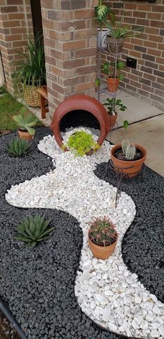 an outdoor garden with rocks and plants