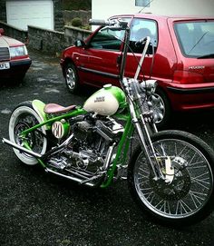 a green and white motorcycle parked in a parking lot