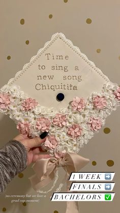 someone is holding up a graduation cap with flowers on it and the words time to sing a new song chiquitia