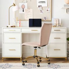 a desk with a chair, laptop and pictures on the wall above it in a room