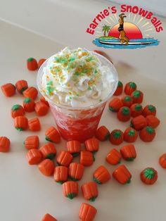 a cup filled with whipped cream and carrots on top of a white countertop