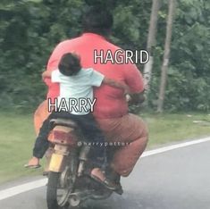 a man riding on the back of a motorcycle with a child sitting on his back