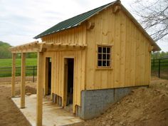 a small wooden building sitting on top of a dirt field