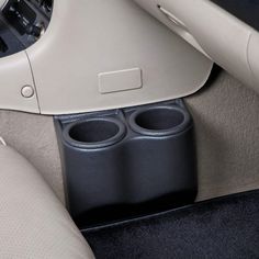 the inside of a car with two cup holders