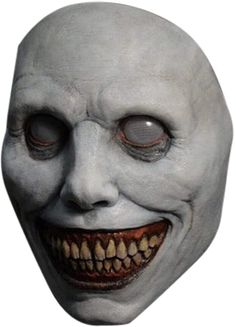 a creepy mask with red eyes and teeth