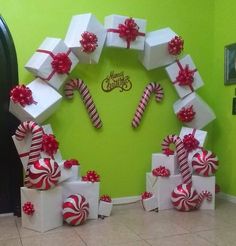 a christmas wreath made out of boxes and candy canes