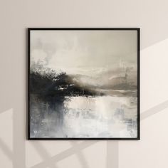 a black and white painting hanging on the wall