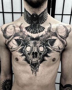 a man with tattoos on his chest has an owl and skull tattoo on it's chest