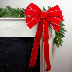 a red bow tied to the side of a fireplace