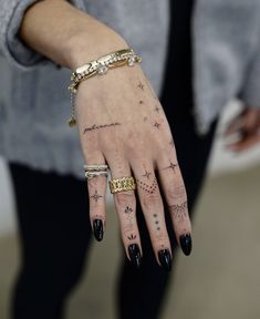 a woman's hand with tattoos on it