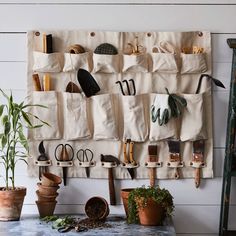 an assortment of gardening tools hanging on a wall