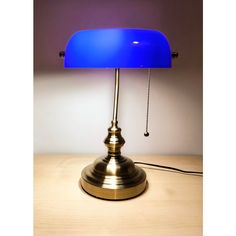 a blue lamp sitting on top of a wooden table