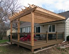 a wooden deck with a pergolan attached to it