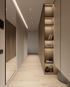 an empty room with wooden shelves and bookshelves on the wall next to it