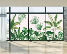 an image of a room with plants on the wall and large windows in front of it