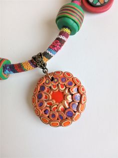 a colorful beaded necklace on a white surface