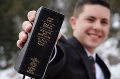 a man in a suit holding up a passport