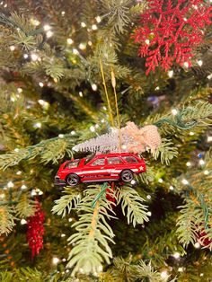 a red car ornament hanging from a christmas tree