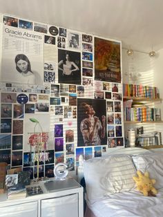 a bedroom with many pictures on the wall